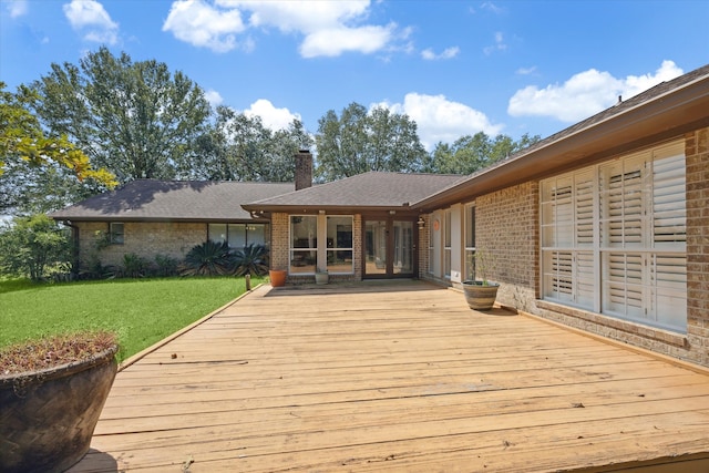 wooden deck featuring a yard