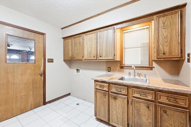 kitchen with light tile patterned floors, a textured ceiling, and sink