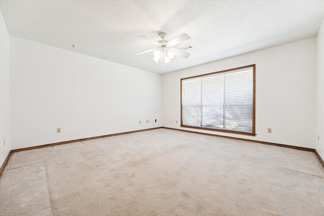 carpeted spare room with ceiling fan