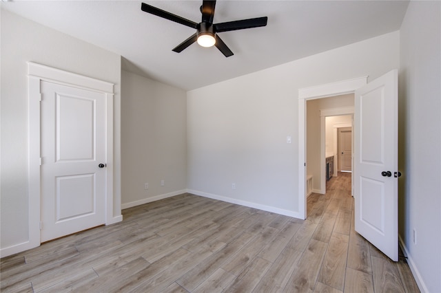 empty room with light hardwood / wood-style flooring and ceiling fan