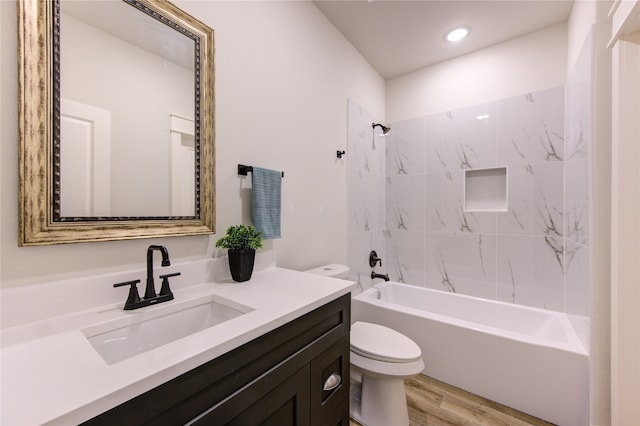 full bathroom with tiled shower / bath combo, vanity, toilet, and hardwood / wood-style floors