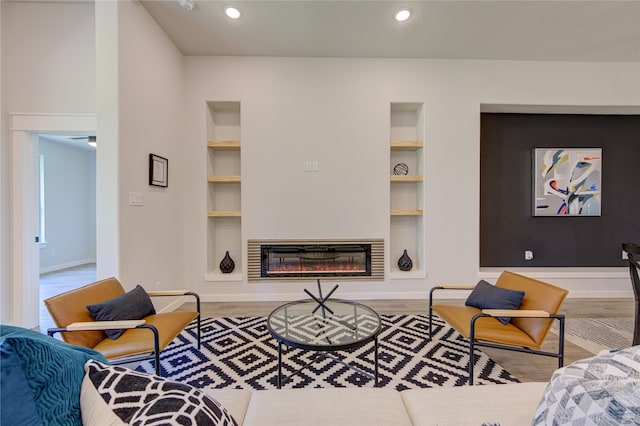 living room featuring light hardwood / wood-style floors and built in shelves