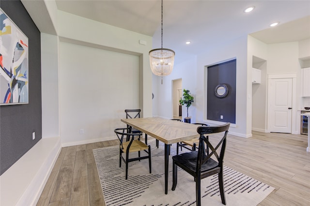 dining room with a notable chandelier and light hardwood / wood-style flooring