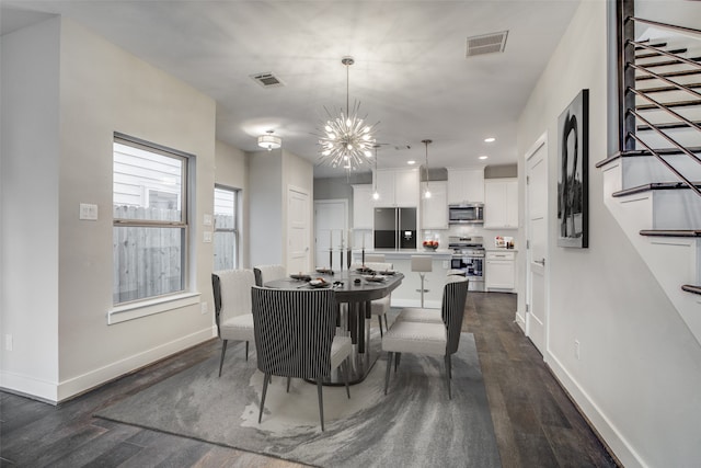 dining area with a chandelier and dark wood-type flooring