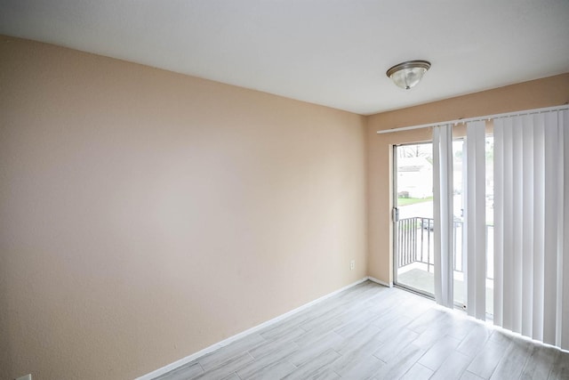 spare room with light wood-type flooring