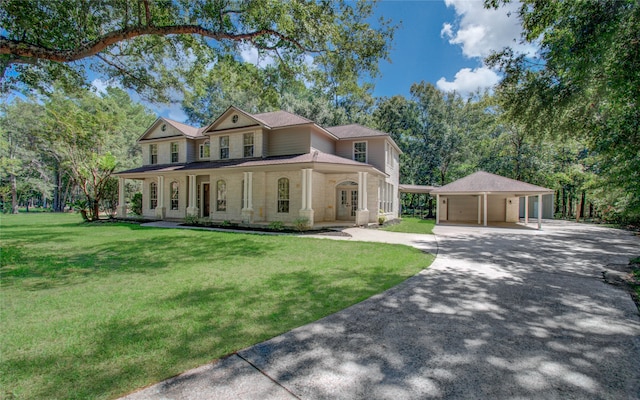 view of front facade featuring covered porch, a front yard, and a carport