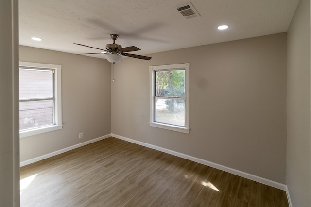 empty room featuring a textured ceiling, ceiling fan, and hardwood / wood-style flooring