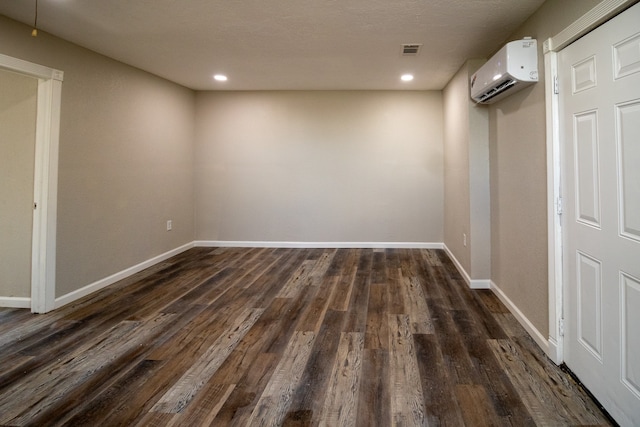 interior space featuring dark hardwood / wood-style floors and a wall mounted AC