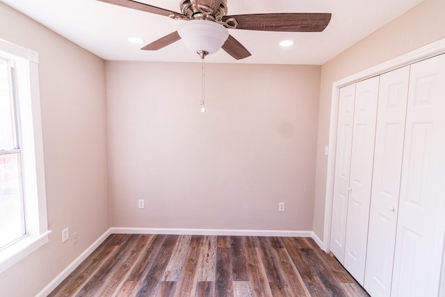 unfurnished bedroom featuring a closet, ceiling fan, and dark hardwood / wood-style flooring