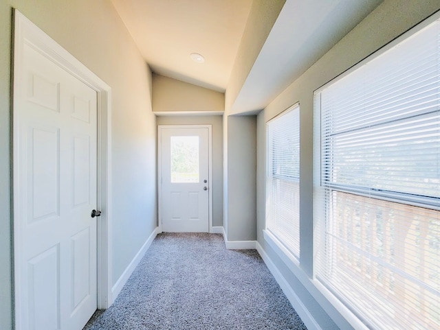 corridor with light carpet and lofted ceiling