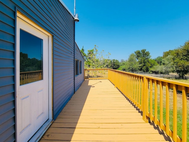 wooden terrace featuring a lawn