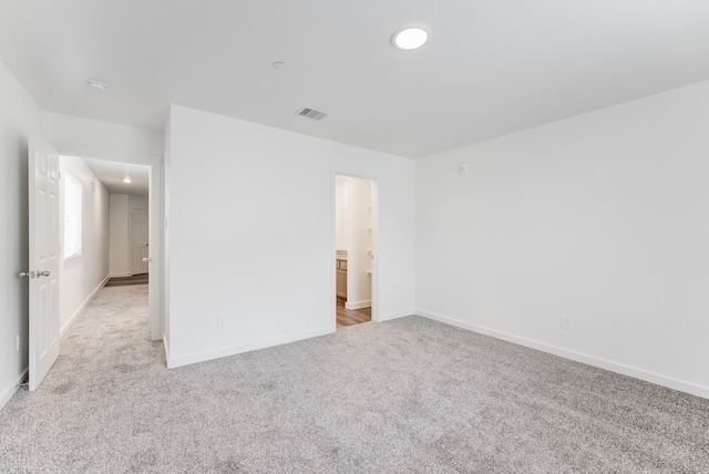 unfurnished bedroom featuring light carpet