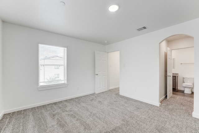 spare room featuring light colored carpet