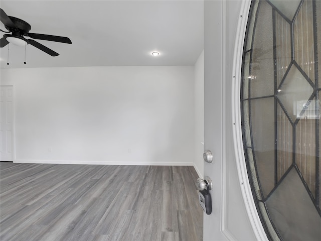 empty room with ceiling fan and hardwood / wood-style flooring