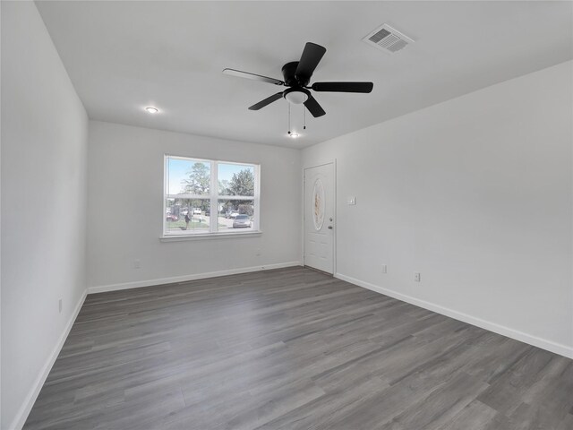 unfurnished room with hardwood / wood-style floors and ceiling fan