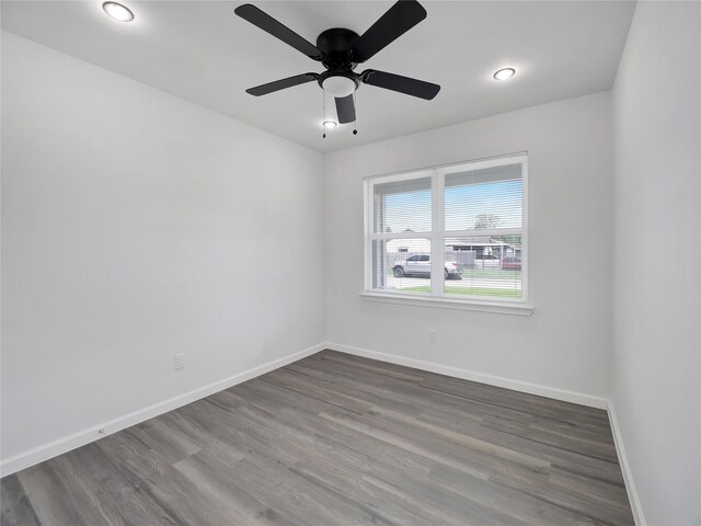 empty room featuring ceiling fan and hardwood / wood-style floors