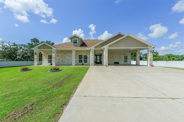 view of front of house featuring a carport, a fire pit, and a front yard