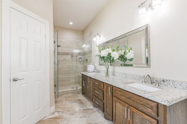 bathroom featuring walk in shower and vanity