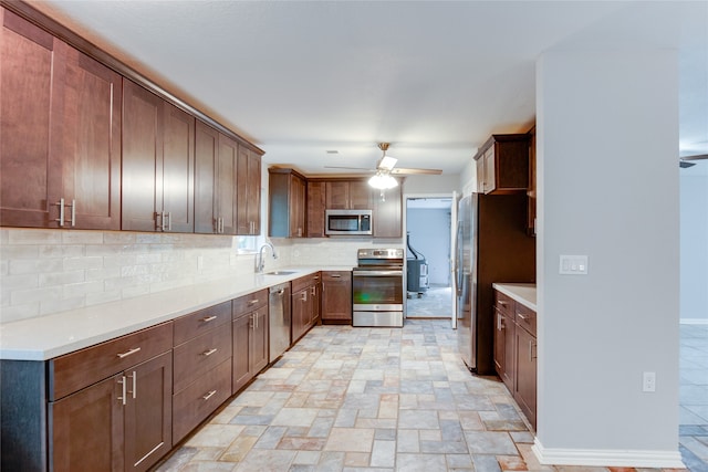 kitchen with ceiling fan, stainless steel appliances, sink, and tasteful backsplash