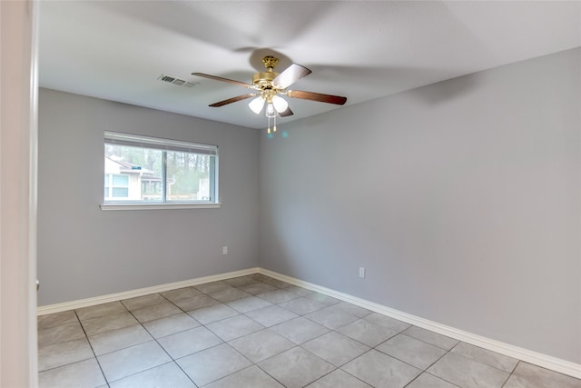 empty room with ceiling fan and light tile patterned flooring