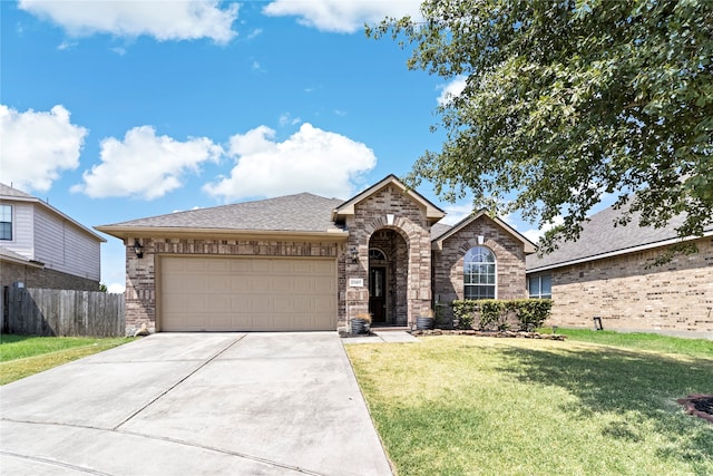 view of front of house with a garage and a front lawn