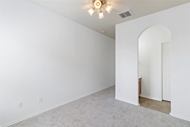 carpeted spare room with ceiling fan