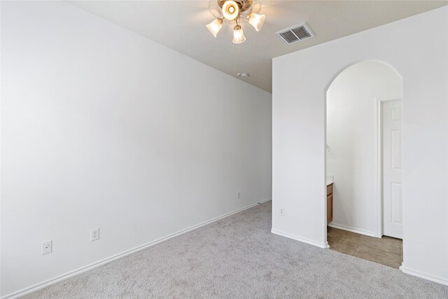 23307 W Pine Ivy Ln, Tomball, TX 77375 - empty room with arched walkways, a ceiling fan, carpet, and baseboards