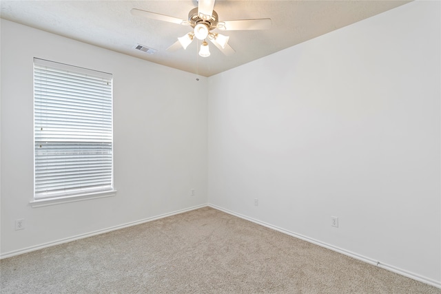 carpeted empty room featuring ceiling fan