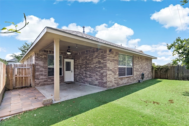 back of house featuring a patio, a lawn, and ceiling fan