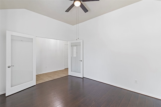 unfurnished bedroom featuring ceiling fan, dark hardwood / wood-style floors, and vaulted ceiling