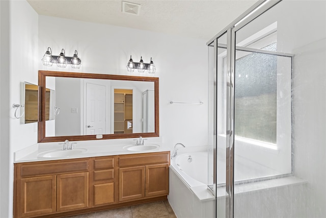 bathroom featuring tile patterned flooring, a textured ceiling, independent shower and bath, and vanity