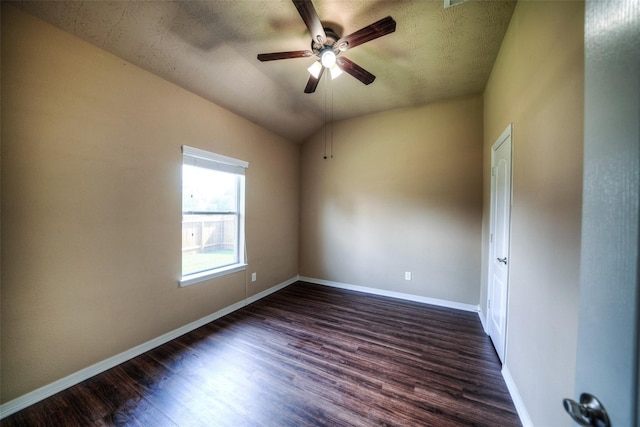 spare room featuring ceiling fan, a textured ceiling, dark hardwood / wood-style floors, and vaulted ceiling