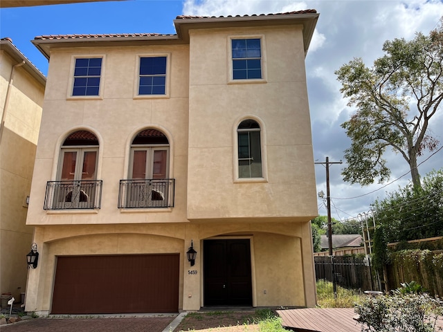 view of front of home featuring a balcony and a garage