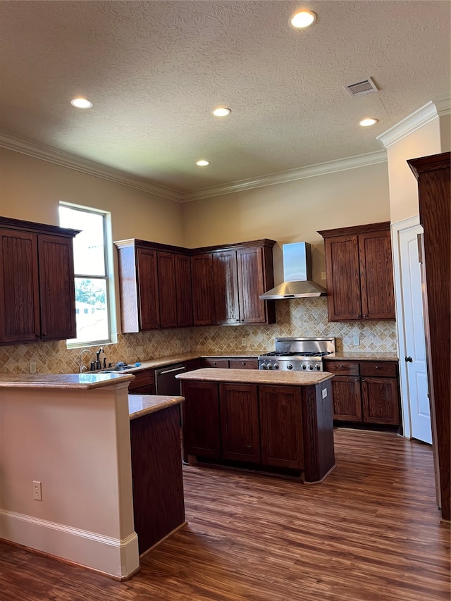 kitchen with crown molding, stainless steel range, dark hardwood / wood-style floors, and wall chimney range hood