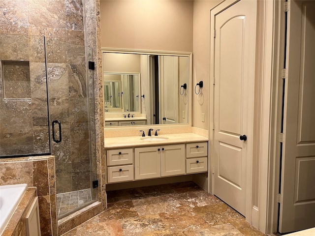 bathroom featuring shower with separate bathtub and vanity