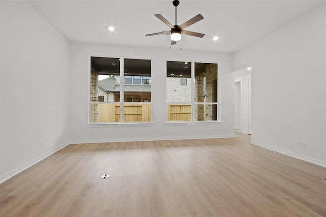 empty room with light wood-type flooring and ceiling fan