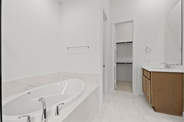 bathroom with vanity and a relaxing tiled tub