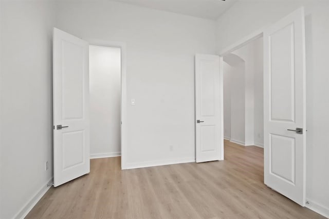 unfurnished bedroom with light wood-type flooring