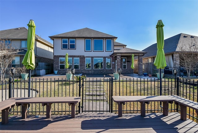 rear view of house featuring a yard and a deck