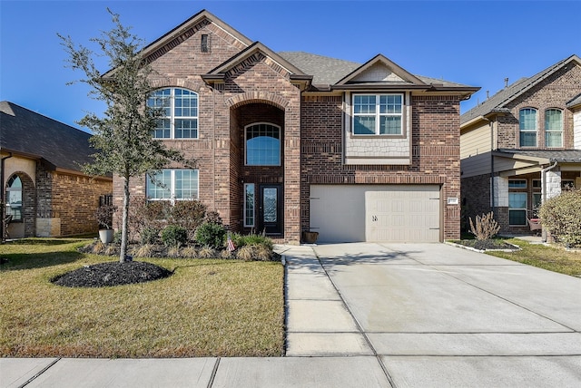 view of front of home with a front yard and a garage