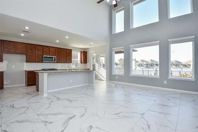 kitchen with a high ceiling, a wealth of natural light, and decorative backsplash