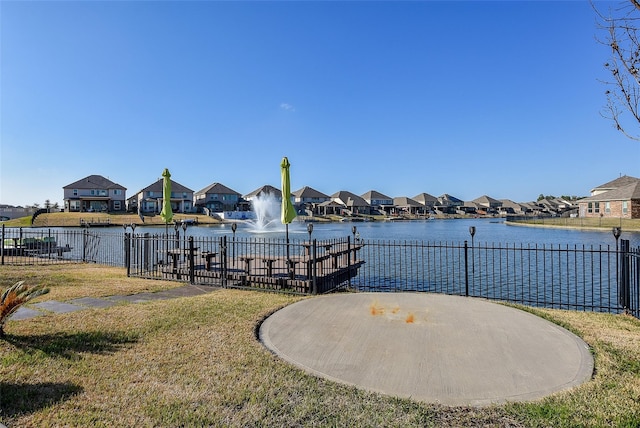 dock area featuring a water view and a yard