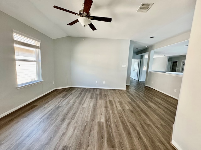 unfurnished living room featuring ceiling fan, vaulted ceiling, and wood-type flooring