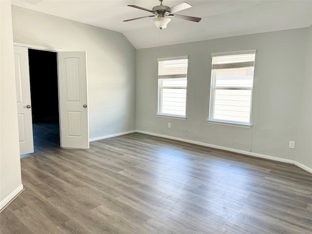 unfurnished room featuring vaulted ceiling, dark hardwood / wood-style flooring, and ceiling fan