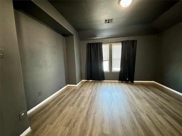 spare room with hardwood / wood-style floors