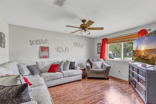 living room with ceiling fan and hardwood / wood-style flooring