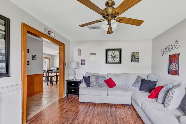 living room with ceiling fan and hardwood / wood-style floors