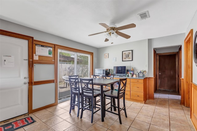 tiled dining space with ceiling fan