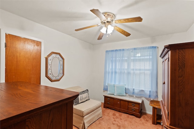 carpeted office space featuring ceiling fan