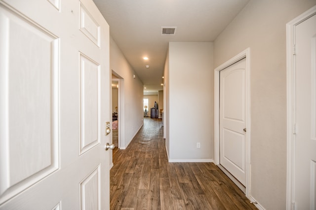 corridor featuring dark wood-type flooring